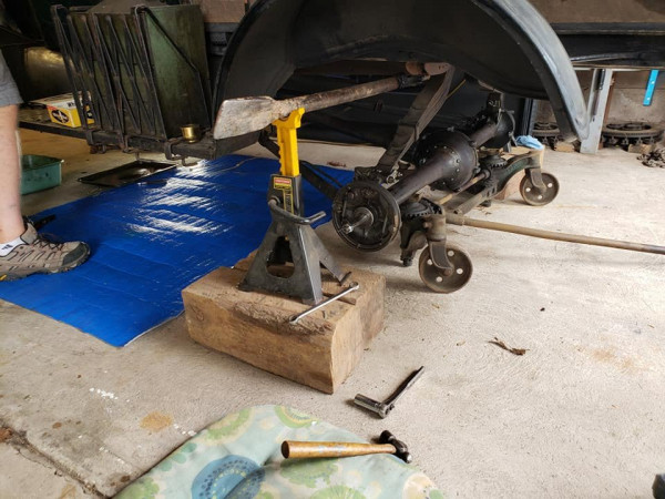 In the car!  The car is supported on my Grandfather's old digging bar made from a New Idea Manure spreader axle.  Real good steel, real heavy and perfect for supporting the back half of a T.