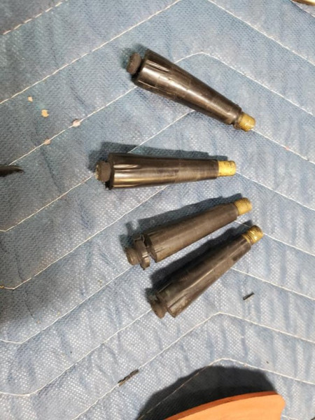 The new valve stems we removed. They are vulcanized to the tube. If you notice, there is hardly a flange at the bottom to reinforce the attachment to the tube. On the other hand, the flange on the brass stems is about the size of a quarter and ribbed for sealing to the new rubber tube when the tube is crimped between the flange and the ribbed bridge washer.