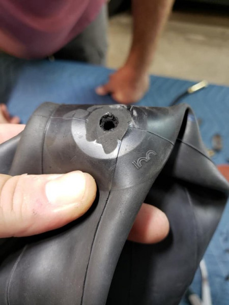 Using an Exacto knife, we cut the sub-par rubber valve stem off the brand new tube! After this photo, we took the tube to the grinder wheel to smooth out the cut, before mounting the valve stem. Makes the tube nice and smooth. Boy i hope this works!