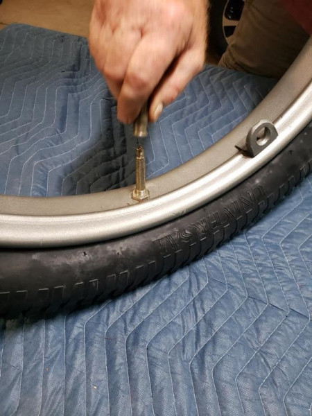 Tire mounted! I prematurely installed the outer retainer nut. This actually goes on the outside of the steel feloe of the wooden spoke wheel.