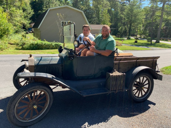 Photo of my brother and I.  My brother behind the wheel getting ready to give me a lesson.