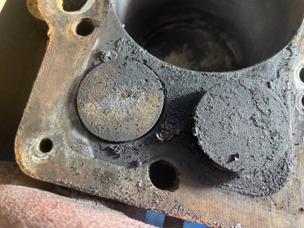 Note whitish stain near the small corner water jacket port and inside the gasket area near the exhaust valve.