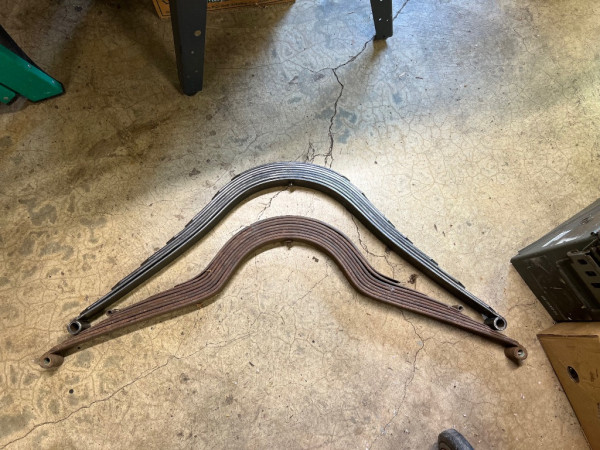 Model A spring on top.  Model T tapered leaf spring on bottom.