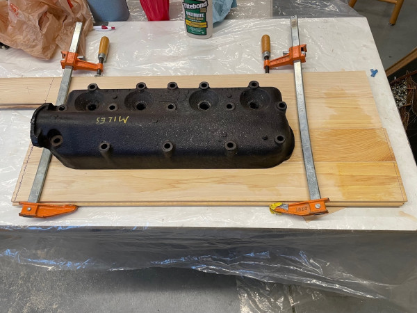 The boards wanted to buckle under pressure from the clamps, but this cast iron head was the right amount of weight to make it lay flat while the glue sets. I’ll add hardwood cleats to the underside once it’s been planed to thickness and trimmed to size.