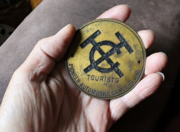 tin can badge in hand.jpg