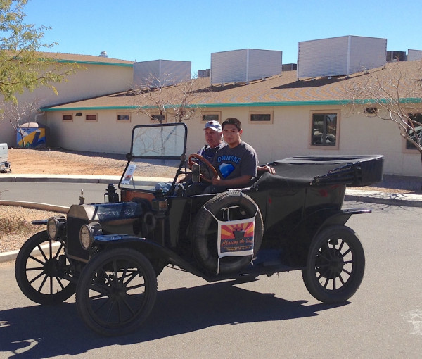 We visited a school.  This young man had received his learner's permit day before, so of course he got a Model T driving lesson!