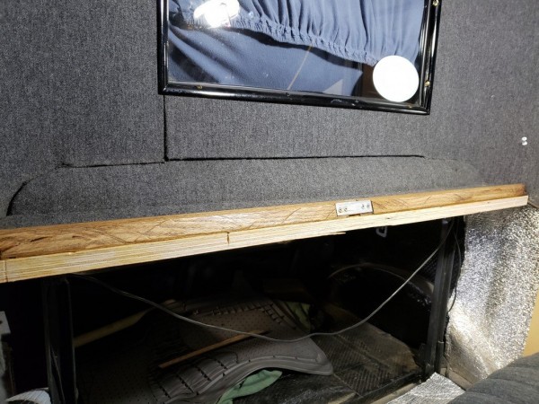 Shelf behind seat remounted to rear body seam only