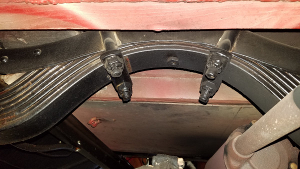 rear spring appears skewed to the passenger side (to the right), clamp on the left has obviously move since the paint job