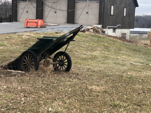 As found, under a tree behind a barn.