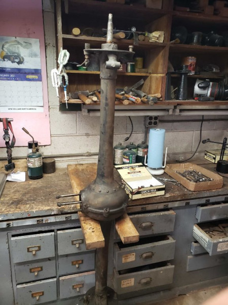 Rear axle jig.  With the wooden plank firmly screwed into the work bench, loosening the bolts to separate the axle halves is a breeze.