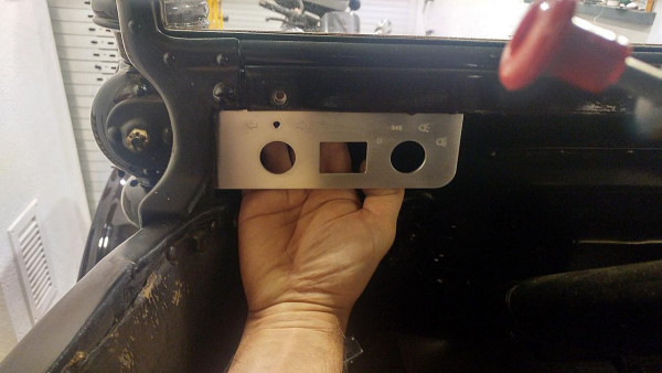 This is the position of my dashboard with switches for direction lights (left switch) and other side lights, low headlights, high headlights (right switch). In upper-right corner you can see the meanwhile removed old switch. This ugly hole drilled below the windshield is reused by my dashboard and comes from the previous Headlight Switch. It is hidden below a little black painted bolt head now.