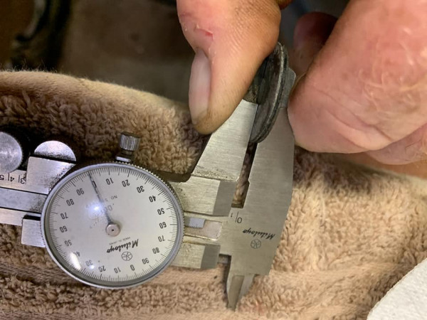 This little disk goes between each separate axle and the thickness has to be altered to eliminate backlash on the differential. Time consuming process, but as I said above, brilliant and simple. Here we are measuring to match thickness per the feeler gauge.